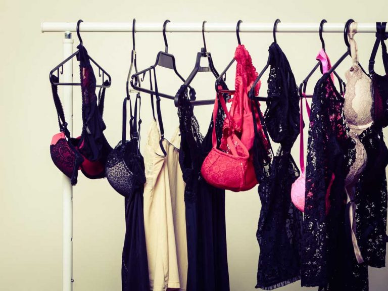 Lace lingerie, slips and camisoles hanging on a white clothes rail