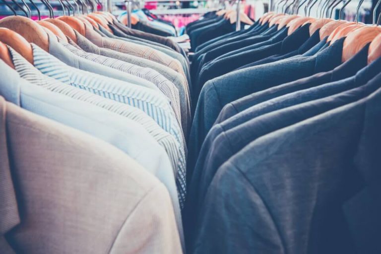 Shirts and jackets hanging on a clothing rail